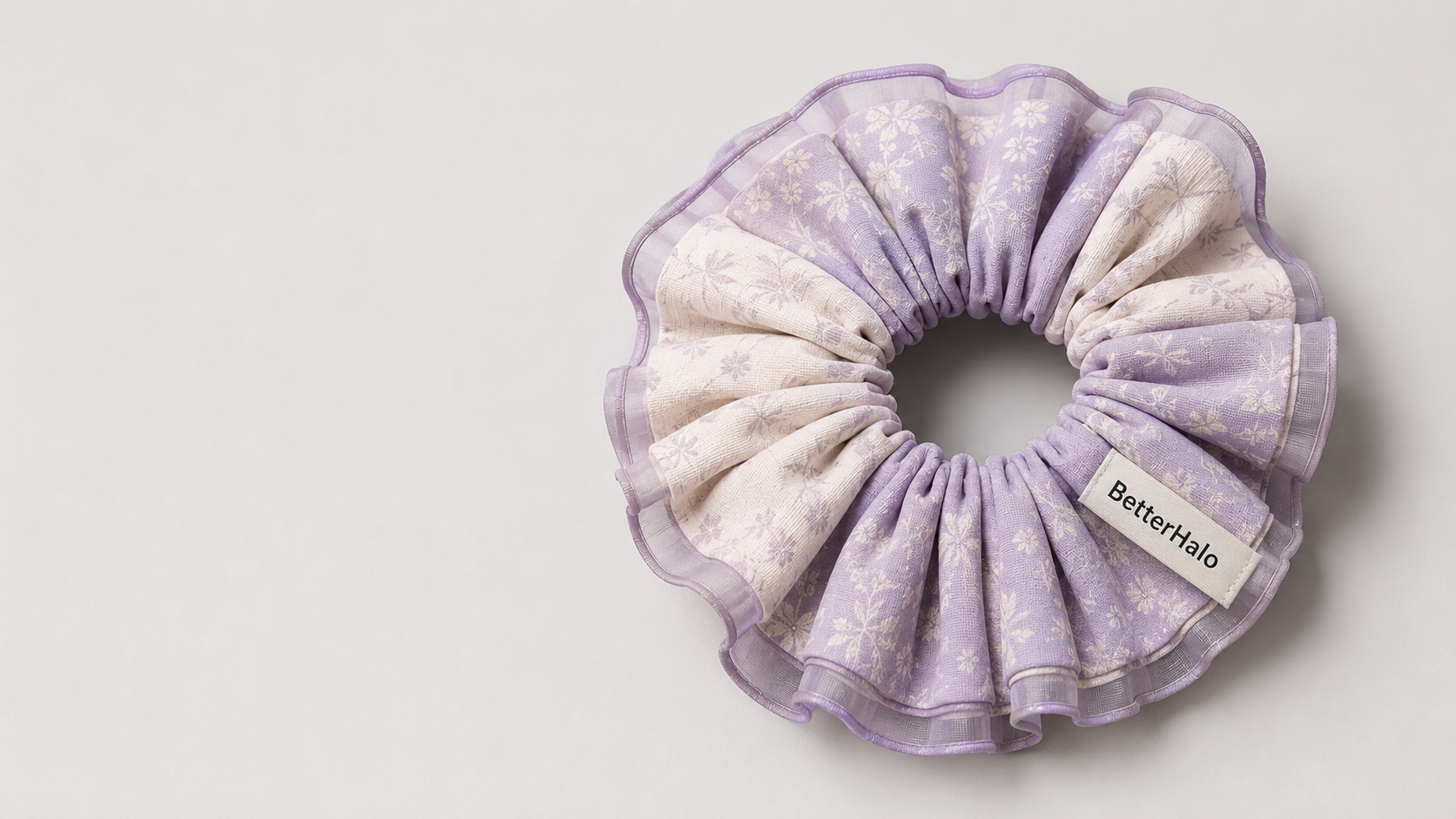 Lavender and cream BetterHalo scrunchie on a soft grey background